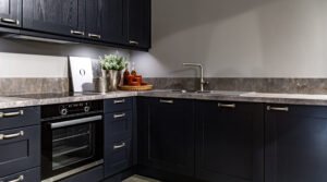 Kitchen Cabinets Dallas TX: How to Choose the Right Style, Finish, and Layout for Your Home-Kitchen Cabinets Dallas TX-Dark kitchen cabinets with metal pulls or knobs in home interior, RTA Kitchen Cabinets vs Custom Cabinets