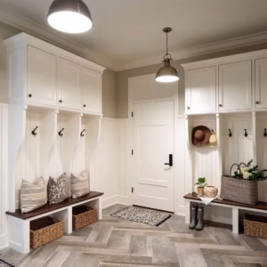 White mudroom cabinets, coat hooks, and bench seating