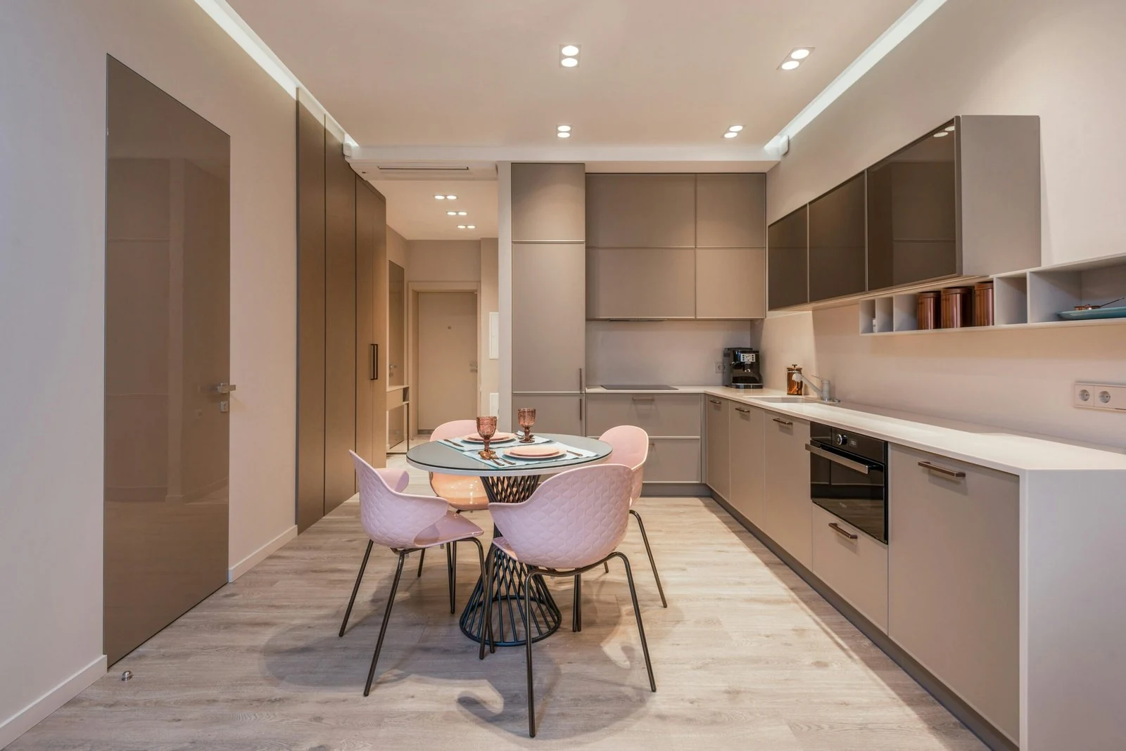 Compact kitchen with flat-front cabinets and a small dining table