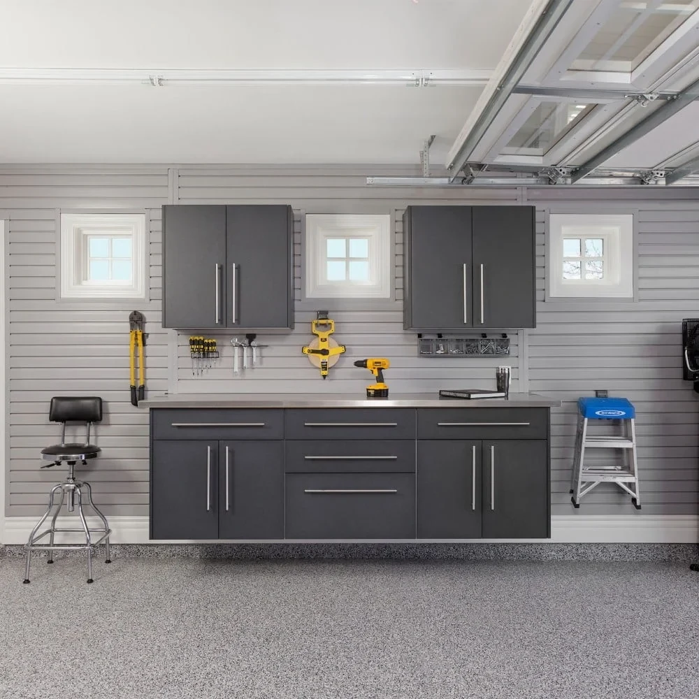 Garage with gray cabinets and a central workbench