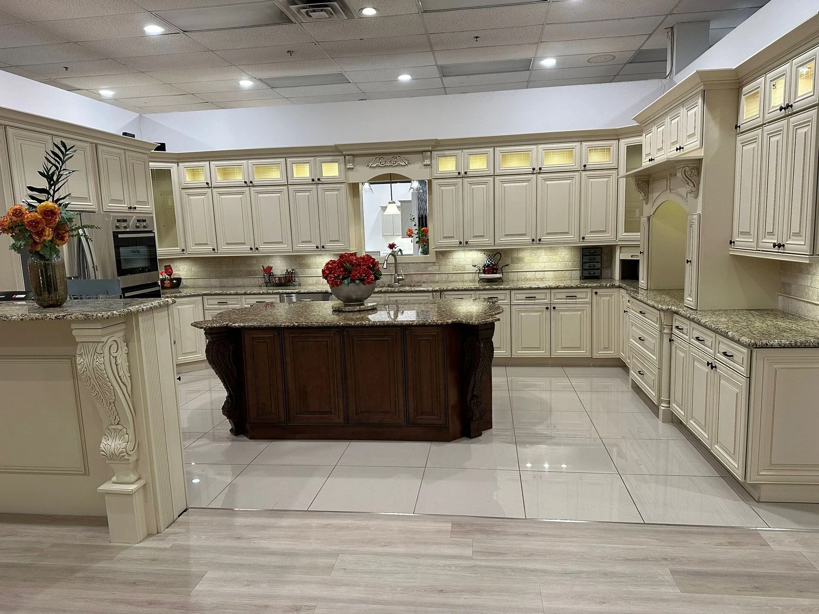 Kitchen with cream cabinetry and a dark wood island