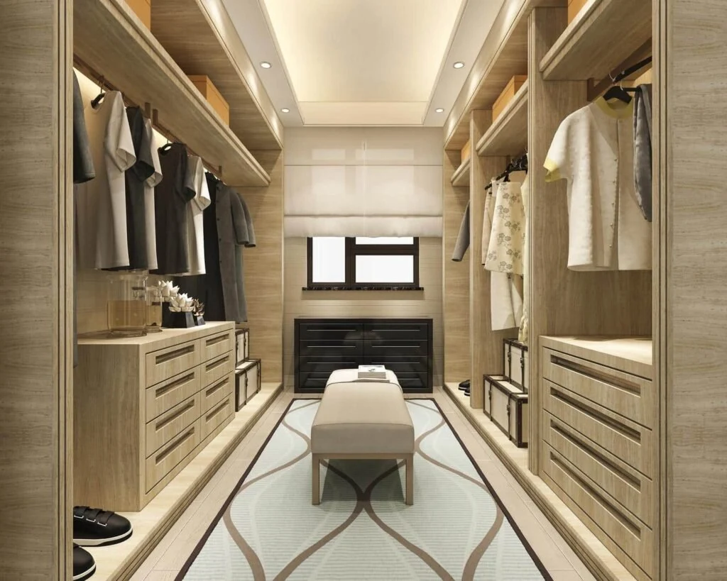 Walk-in closet with drawer banks, hanging rails, and a central bench