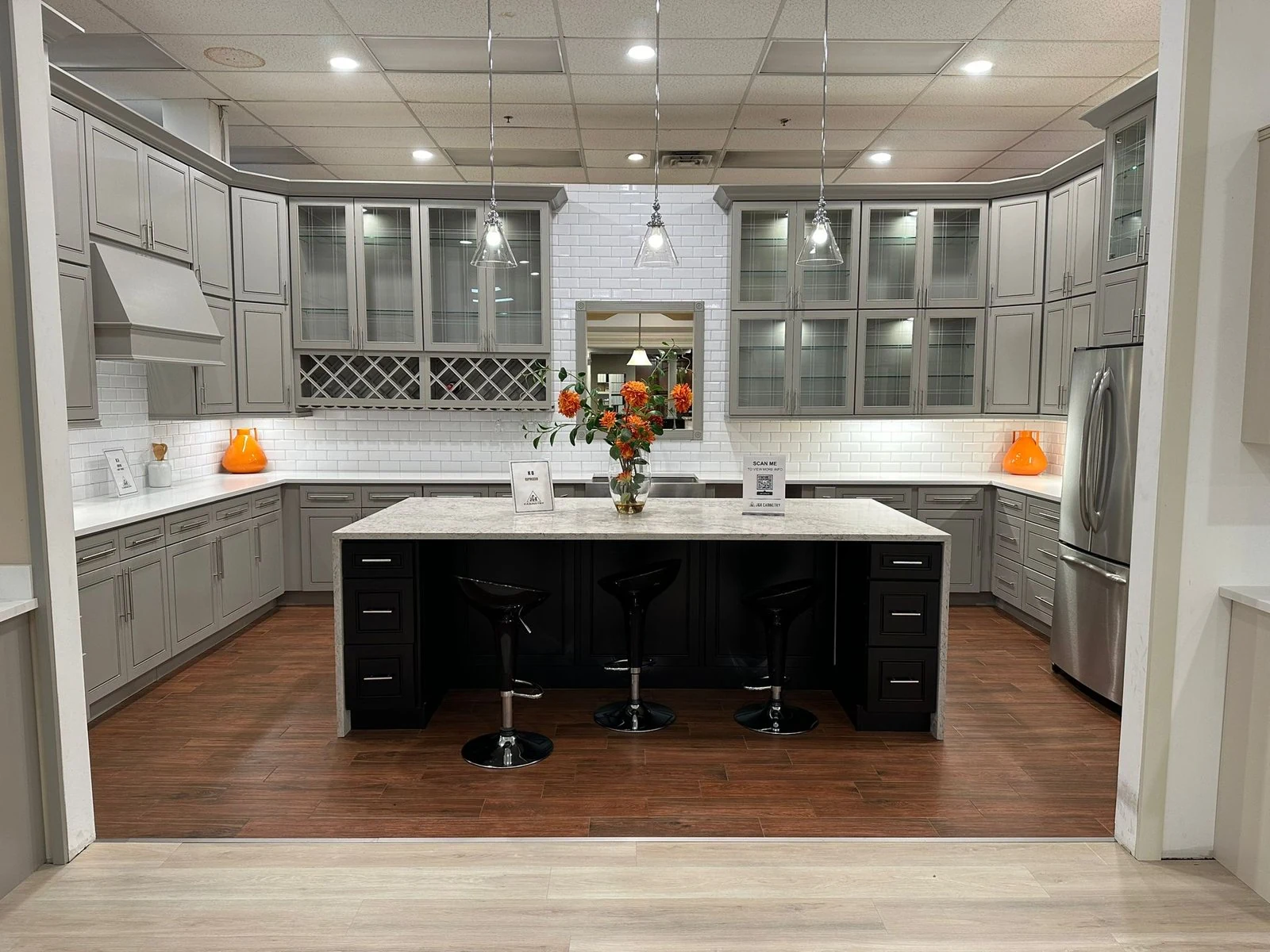Kitchen with light cabinets and a contrasting dark island
