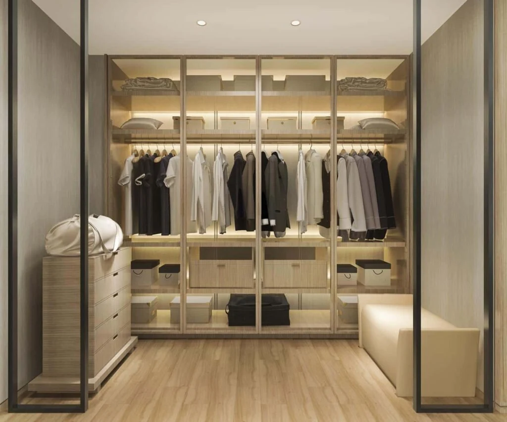 Illuminated wardrobe with open hanging rails and shelves