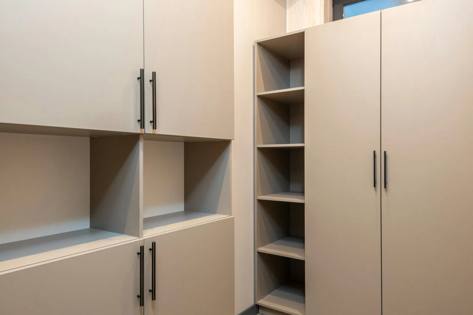 Built-in cabinet with a counter, upper cupboards, and open side shelves