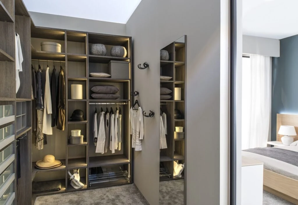 Compact walk-in closet with drawers, shelves, and hanging rails