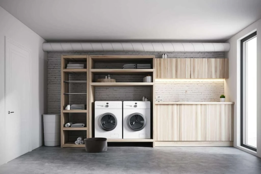 Laundry room with a washer, dryer, and built-in cabinets