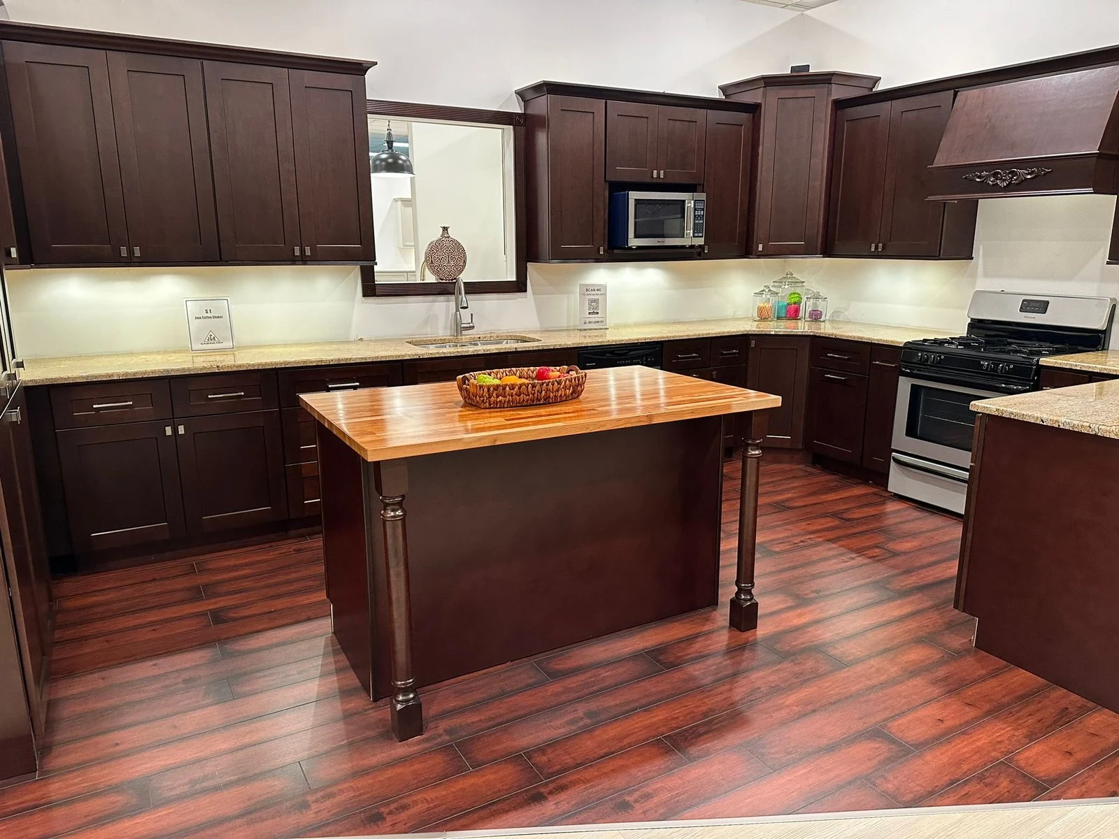 Kitchen with dark wood cabinetry and a central island